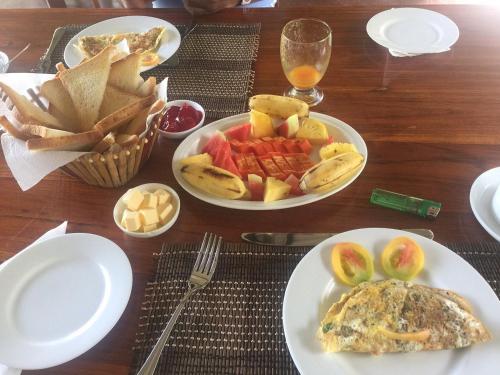 a table with two plates of food and french fries at Rajarata Family Resort in Anuradhapura