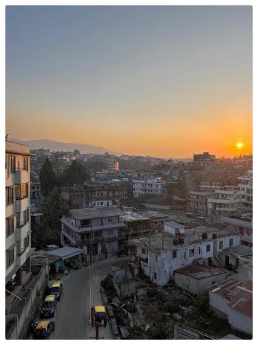 a view of a city with the sunset in the background at Stargaze Backpackers Shillong in Shillong