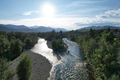 an aerial view of a river with trees at Methow River Lodge and Cabins in Winthrop
