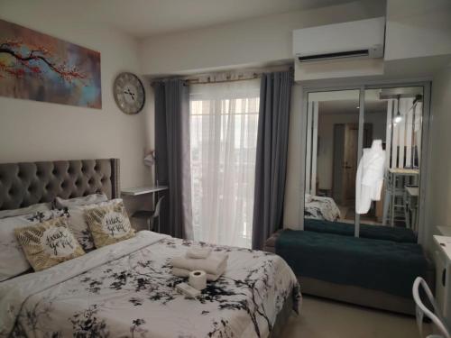 a bedroom with a bed with a teddy bear on it at Inspiria Condo Davao - Olivia's Haven in Davao City