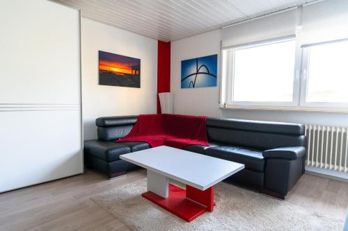 a living room with a couch and a table at Exklusives Business Apartment in Lörrach