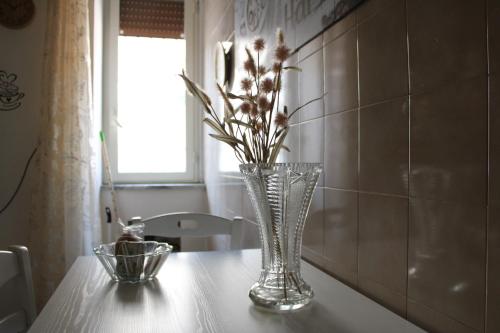 a vase with flowers in it sitting on a table at La Casa di Carlotta in Naples