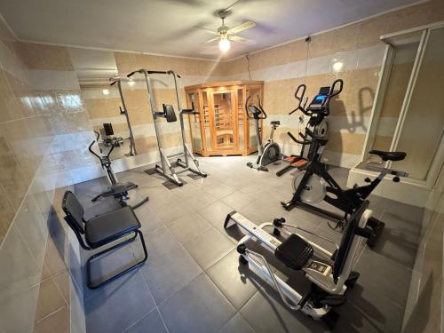 a gym with several treadmills and exercise bikes at Villa Agni in Barvaux