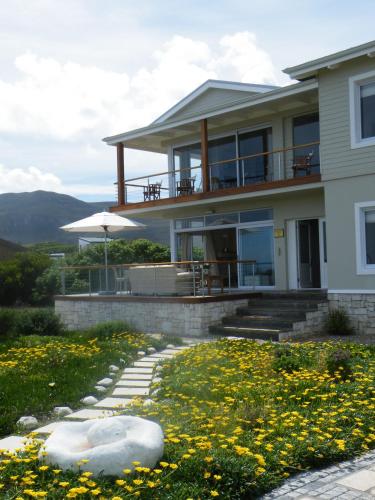 a house with a walkway in front of it at 138 Marine Beachfront Guesthouse in Hermanus