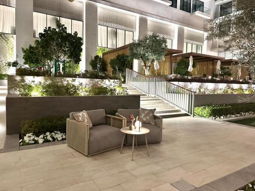 a lobby of a building with a couch and a table at Address Beach Resort Residences Bahrain in Manama