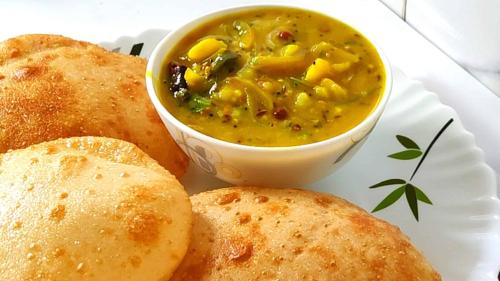 a plate of food with a bowl of soup and bread at Sea Wander Beach Resort in Mandarmoni
