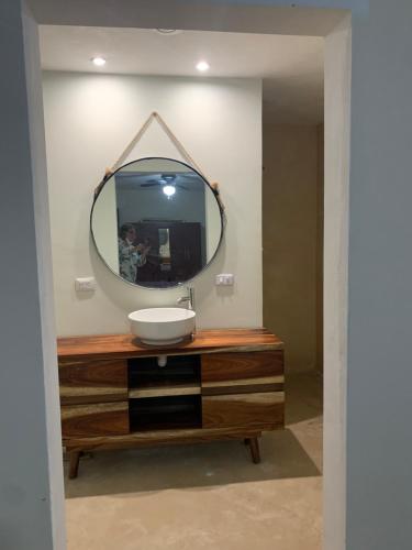 a bathroom with a sink and a mirror on a dresser at La Casa Frida in Mérida
