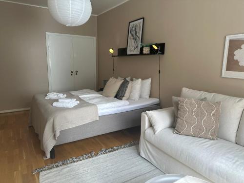 a living room with a bed and a couch at Hotel Tre Små Rum in Stockholm