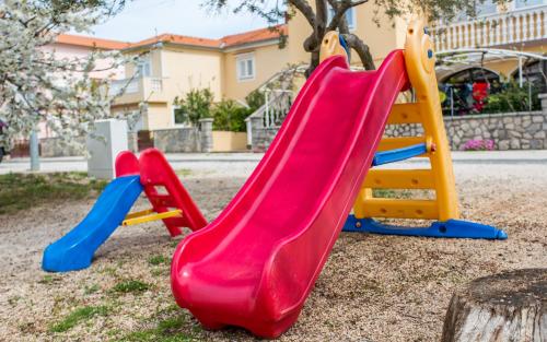 three kids slides at a playground at Pansion Tina in Šilo
