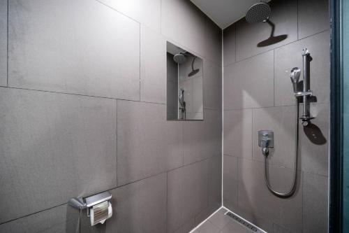 a bathroom with a shower with a glass door at JB Design Hotel in Busan