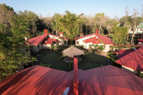 an aerial view of a house with an umbrella at Palash Kothi -Bandhavgarh in Tāla