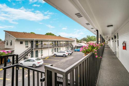 a balcony of a hotel with cars parked in a parking lot at Redamo Suites in Jefferson