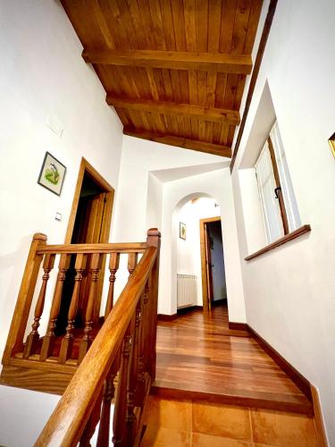 a staircase in a house with a wooden ceiling at Viviendas Rurales El Cantón in Cucayo