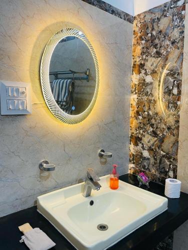 a bathroom with a sink and a mirror at Pine Wood Villa in Mānānwāla