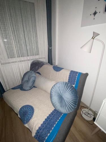 two pillows on a bed in a room at Szeged Sunshine Apartman in Szeged