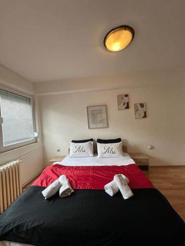 a bedroom with a bed with two towels on it at Aleks 4 in Skopje