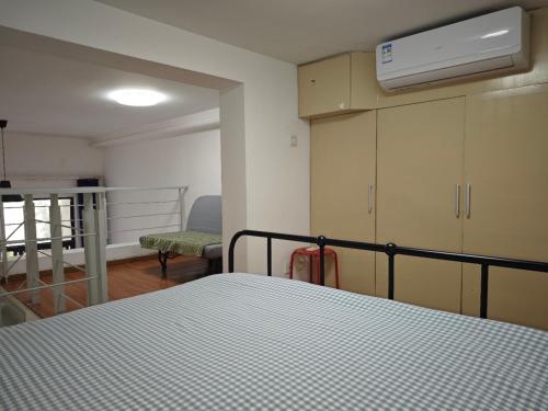 a bedroom with a bed and a room with a balcony at iNestin Shanghai Apt Xinjinqiao Road in Shanghai