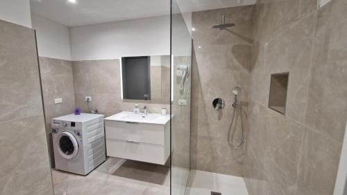 a bathroom with a shower and a washing machine at Canaletto Apartment Rialto in Venice