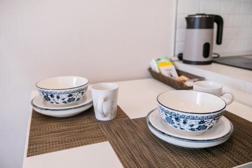 three cups and saucers sitting on a kitchen counter at Modern Condo in Nimman P605 by Pimolplace in Chiang Mai