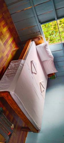 a bed with white sheets and pillows in a room at Sweet View Guesthouse in Koh Rong