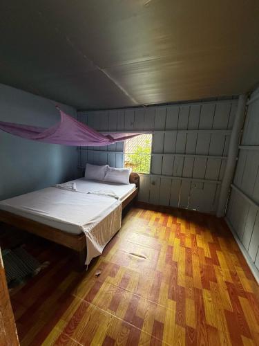 a bedroom with a bed and a window at Sweet View Guesthouse in Koh Rong