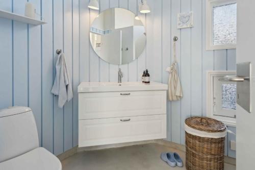a bathroom with a sink and a mirror at Lovely Summer House With Sea View in Sjølund