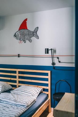 a bedroom with a bed with a fish on the wall at CsakAkali in Balatonakali