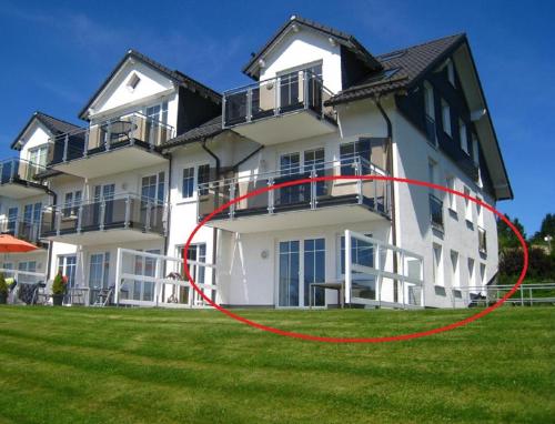 a large white building with a red circle in front of it at Ferienwohnung Sauerland Winterberg mit Traumhaftem Blick ins Tal in Winterberg