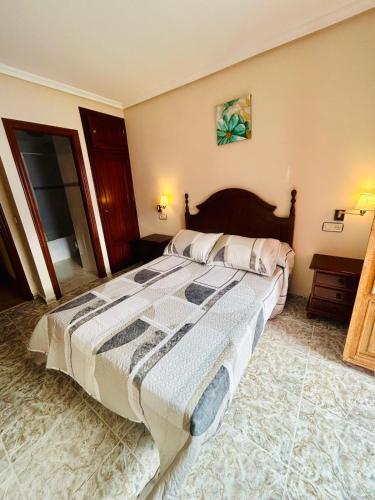 a bedroom with a large bed in a room at Hotel las Palmeras Suite in Celorio