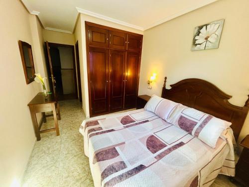 a bedroom with a bed and a clock on the wall at Hotel las Palmeras Suite in Celorio