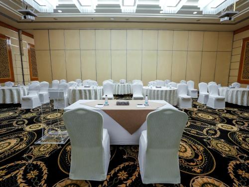 a banquet hall with white tables and chairs at Sheraton Dammam Hotel & Convention Centre in Dammam