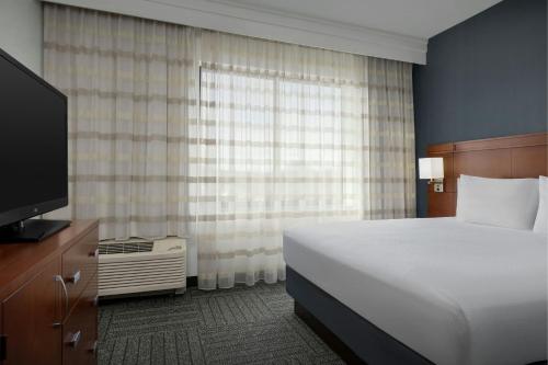 a hotel room with a bed and a television at Courtyard by Marriott Salisbury in Salisbury