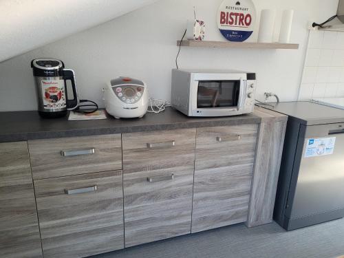 a microwave sitting on top of a counter in a kitchen at Appartement T3 60m2 calme in Morez