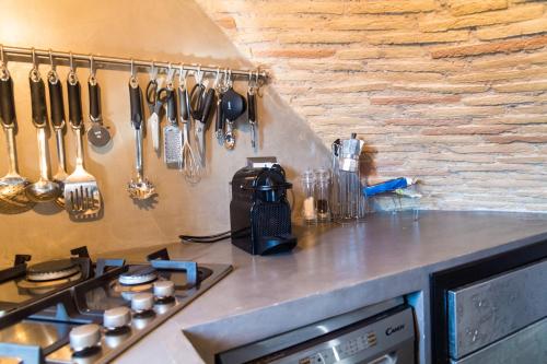 a kitchen with a counter with utensils on the wall at Luxury House FV in Formello