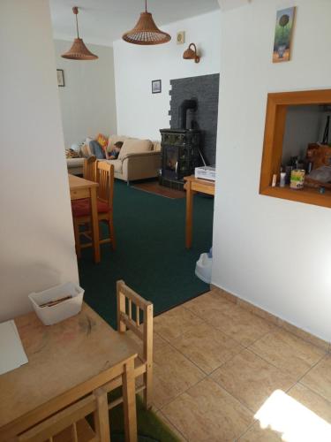 a living room with a table and a couch at U Fary in Jestrabi V Krkonosich