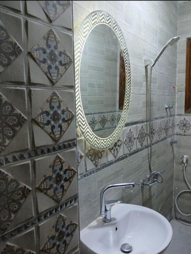 a bathroom with a sink and a mirror at 378 Pyramids St -Two bedrooms Hotel Apartment in Cairo