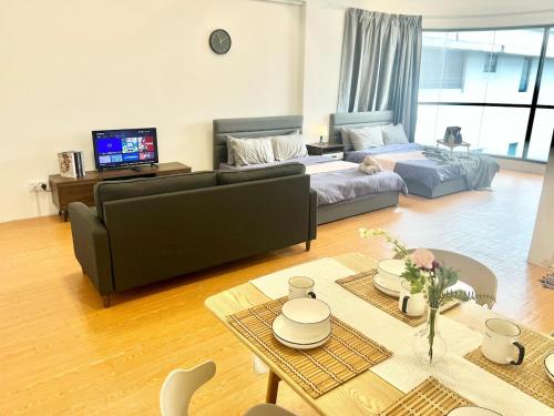 a living room with a couch and a table at G10 6Pax Sunway Medical Center Geo Avenue WiFi TV in Subang Jaya