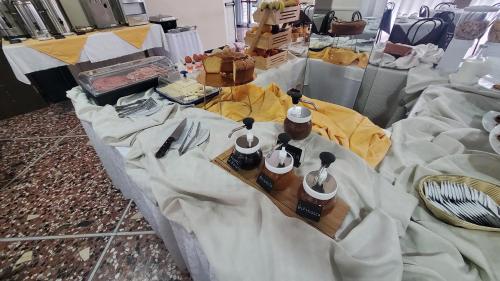 a table covered in white sheets with items on it at Alevon Hotel in Rimini