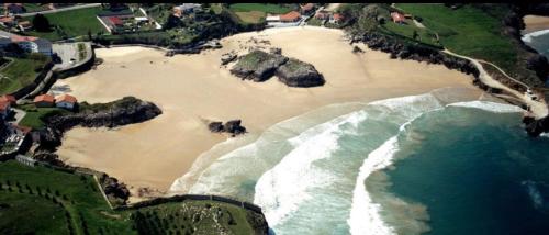 an aerial view of a beach with rocks and water at Hotel las Palmeras Suite in Celorio