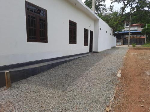 a side view of a white building at Black Rose Guest in Gampaha
