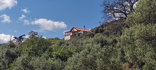a house on the side of a hill with trees at Vasiliki's Residence Amazing View in Kissamos