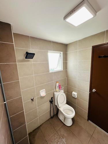 a bathroom with a toilet and a window at Embun Homestay Puchong SemiD 1-10Pax 6-7CarPark in Puchong