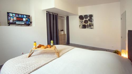 a bedroom with a bed with a tray of fruit on it at Apparemment t3 au cœur champenois in Charly-sur-Marne