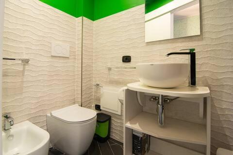 a bathroom with a white sink and a toilet at Al ViaVai in San Cosmo Albanese
