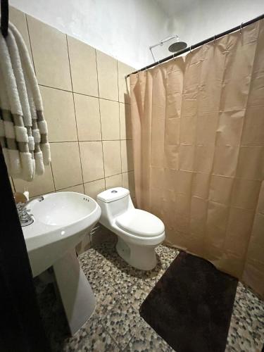 a bathroom with a toilet and a sink at Casa Quintana in Bacalar