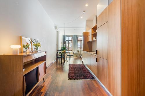 a living room with wooden cabinets and a dining room at Hey Apartments C in Porto