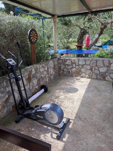 a exercise bike parked next to a stone wall at Villa Mali Raj in Zaton