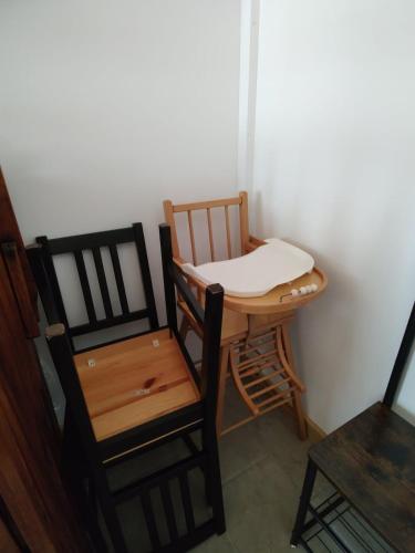 a room with two chairs and a table and a stool at Le Logis de Jade in Saint-Léon
