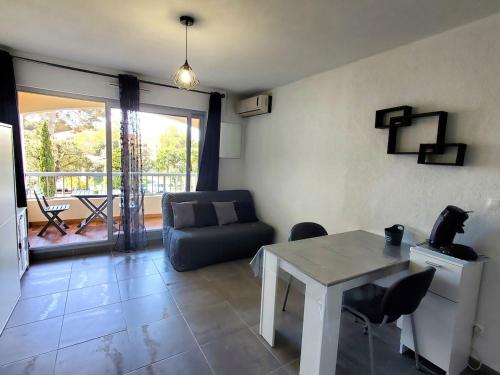 un salon avec une table et un canapé dans l'établissement Studio climatisé proche de la plage de Sainte Asile, à Saint-Mandrier-sur-Mer