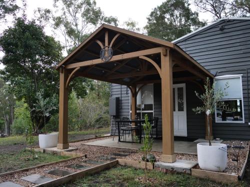 a pavilion over a porch of a house at Kookaburra Retreat in Daylesford